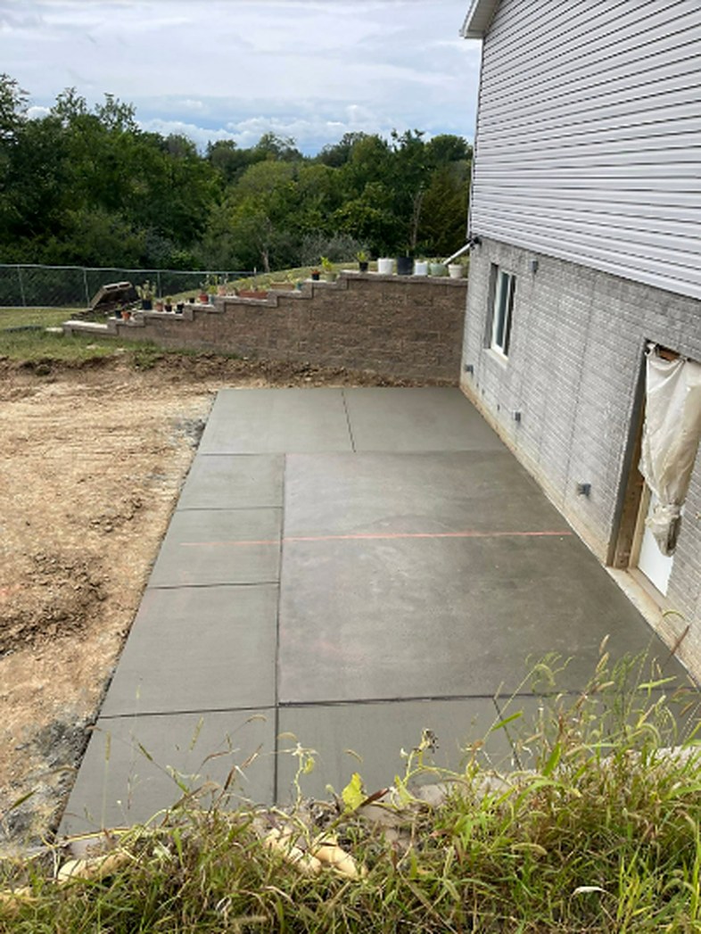 Hillside concrete patio poured beside a walkout home by Twins Concrete in Nebraska