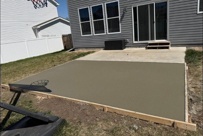 Concrete patio extension freshly poured by Twins Concrete in Lincoln, Nebraska
