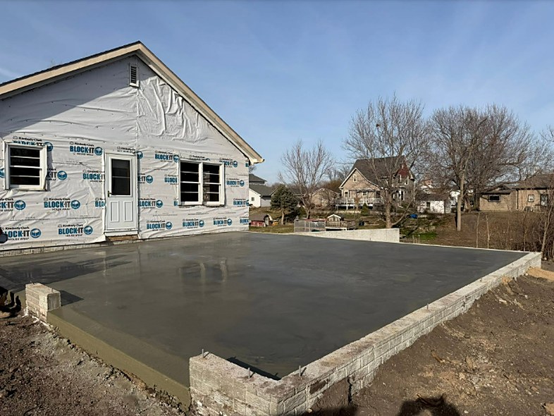 Cured concrete slab with block foundation walls poured by Twins Concrete in Nebraska